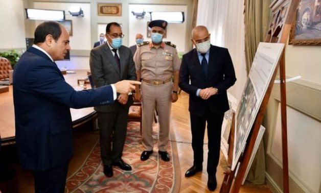 President Abdel Fatah al-Sisi checking a plan of construction works on August 24, 2021. Press Photo 
