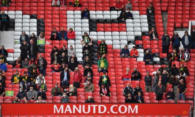 Manchester United fans inside Old Trafford stadium before the match as a limited number of fans are permitted at outdoor sports venues Pool via REUTERS/Paul Ellis