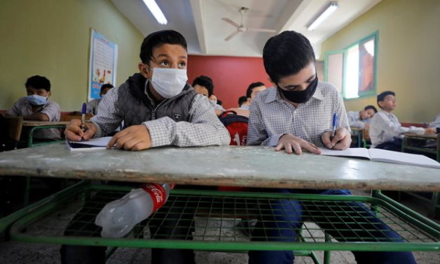 Students wearing protective masks attend the first day's class at Al Sadeeya school, following months of closure due to the coronavirus disease (COVID-19) outbreak in Cairo, Egypt October 17, 2020. (Reuters)