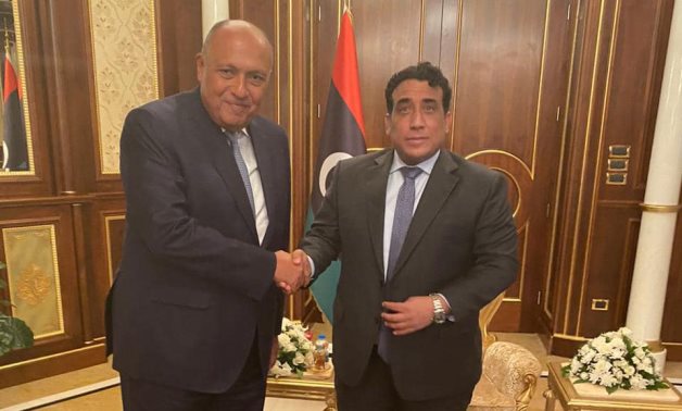 Egypt's Foreign Minister Sameh Shoukry (L) shakes hands with Libya’s Presidential Council Mohammad Menfi in Tripoli, 21 October 2021 - Egyptian Foreign Ministry