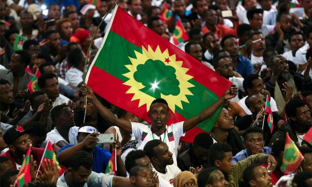 FILE - An Ethiopian man holding an Oromo Liberation Front (OLF) flag – Wikimedia Commons