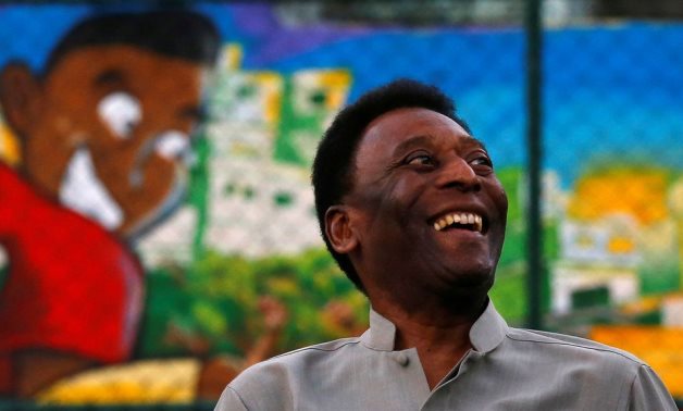 Pele laughs during the inauguration of a refurbished soccer field at the Mineira slum in Rio de Janeiro September 10, 2014. REUTERS/Ricardo Moraes