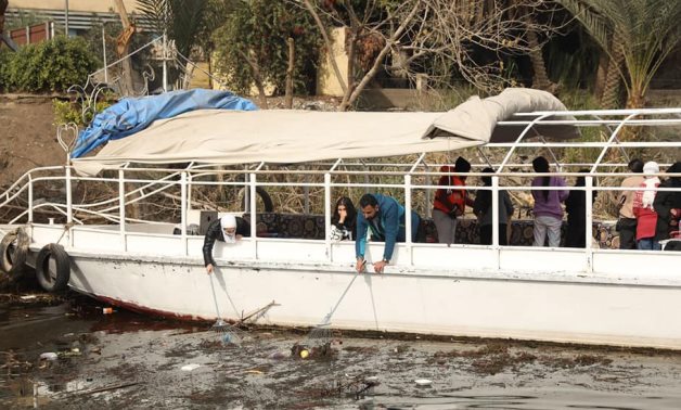 Students collect plastic waste from the Nile river on December 24, 2021, under the auspices of the Ministry of Water Resources- press photos