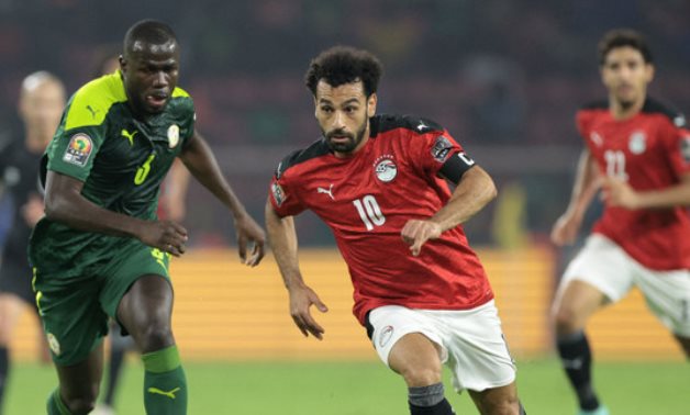 Senegal's defender Kalidou Koulibaly (L) fights for the ball with Egypt's forward Mohamed Salah during the AFCON 2021 final football match in Yaounde on Feb. 6, 2022. (AFP)