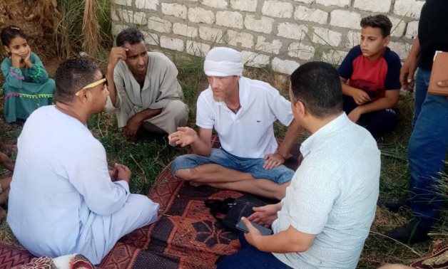British tourist Benjamin sitting with Al-Dabya village residents 