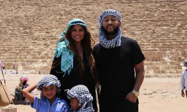 File: John Legend along with his wife acclaimed motivational speaker Chrissy Teigen and their kids in the Giza Pyramids.