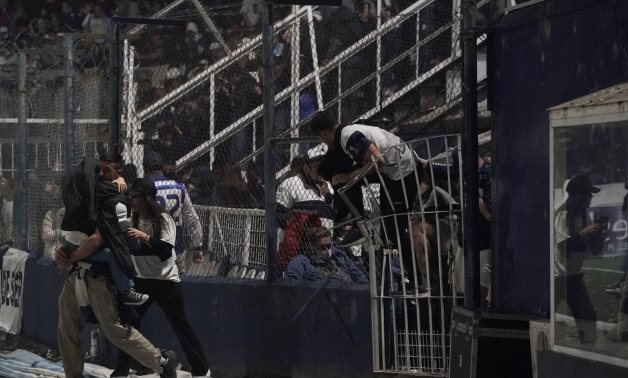 Fans of Gimnasia y Esgrima La Plata affected by tear gas invade the field, at Juan Carmelo Zerillo Stadium. REUTERS/Jose Brusco