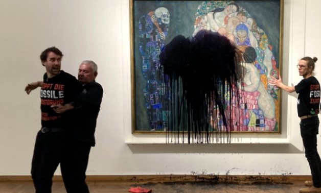 Two activists from the group Last Generation poured black liquid on a screen protecting Gustav Klimt's painting 'Death and Life' - Associated Press