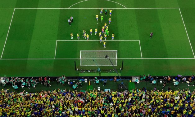 Brazil players celebrate with fans after the match REUTERS/Peter Cziborra
