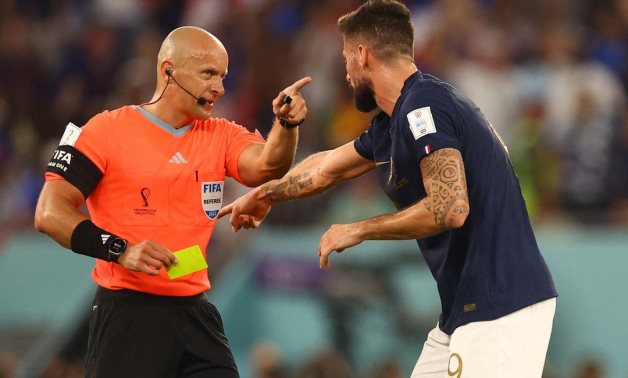 France's Olivier Giroud reacts towards referee Szymon Marciniak before he shows Denmark's Andreas Christensen a yellow card for a foul on Kylian Mbappe REUTERS/Hannah Mckay