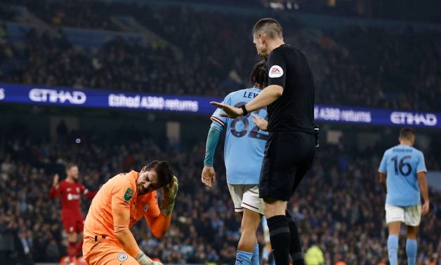 Manchester City's Stefan Ortega reacts after sustaining an injury after colliding with Aymeric Laporte as referee David Coote looks on Action Images via Reuters/Jason Cairnduff