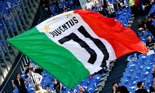 A Juventus fan waves a flag inside the stadium before the match REUTERS/Ciro De Luca