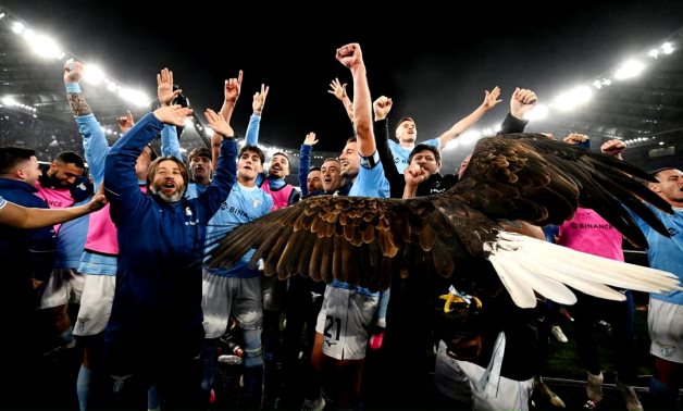 Lazio players celebrate with mascot Olympia the eagle after the match REUTERS/Alberto Lingria