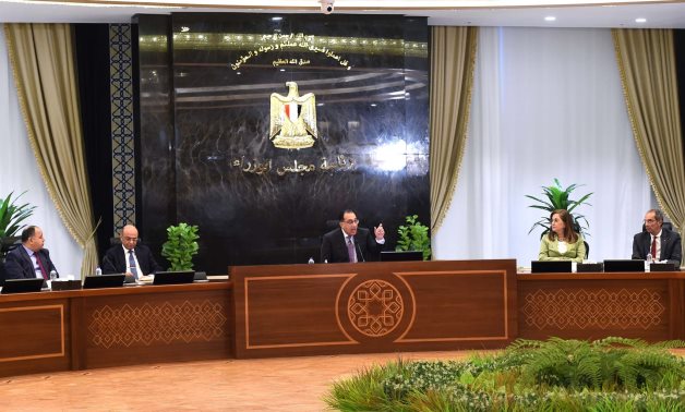 Prime Minister Moustafa Madbouli examines the results from the initial session of the Supreme Council for Investment - Press Photo