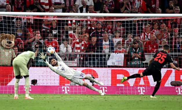 Bayer Leverkusen's Exequiel Palacios scores their second goal from the penalty spot past Bayern Munich's Sven Ulreich REUTERS/Angelika Warmuth