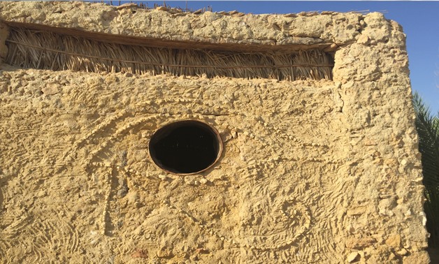 Karshif building decorated with the Eye of Horus, Siwa Oasis - Monika Sleszynska