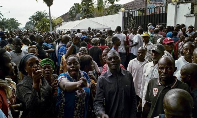 Supporters of the Congolese main opposition part Union for Democracy and Social Progress (UDPS) shout slogans as they gather outside the residence of the late veteran opposition leader Etienne Tshisekedi in the Limete Municipality in Kinshasa, Democratic 