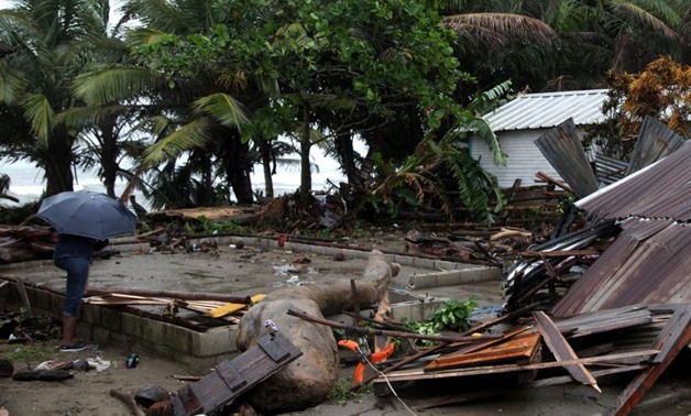 People look at what is left of their home in Nagua. REUTERS/Ricardo Rojas