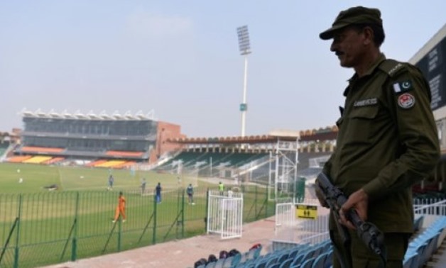  A Pakistani policeman stands guard while national cricket team players take part in a practice session at the Gaddafi Cricket Stadium in Lahore on September 8, 2017, for the forthcoming World XI tour to Pakistan.