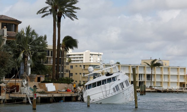 SeaTow workers attempt to save a damaged motor yacht in the Hillsboro Inlet, following the passing of Hurricane Irma in Pompano Beach - REUTERS