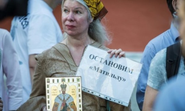 A woman holds an icon of the canonised last Russian tsar Nicholas II and a sign reading "stop Matilda" during a protest against a new movie about his relationship with a ballerina