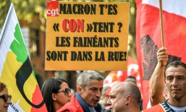Demonstrators in the city of Lille hold a sign reading 'The slackers (faineants) are in the street'