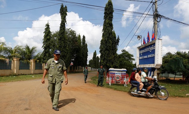 Policemen stand guard in front of the Correctional Center N.3 in Tbong Khmom - REUTERS