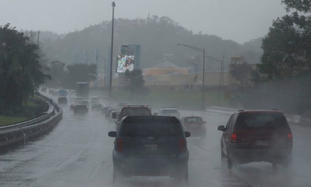 Cars drive on a highway during rain before the arrival of the Hurricane Maria in San Juan, Puerto Rico September 19, 2017. REUTERS/Carlos Garcia Rawlins
