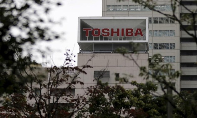 The logo of Toshiba Corp is seen behind trees at its headquarters in Tokyo, Japan October 1, 2015 -
 REUTERS/Toru Hanai/File Photo