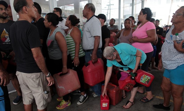 People line up to buy gasoline at a gas station after the area was hit by Hurricane Maria, in San Juan, Puerto Rico September 22, 2017. REUTERS/Alvin Baez
