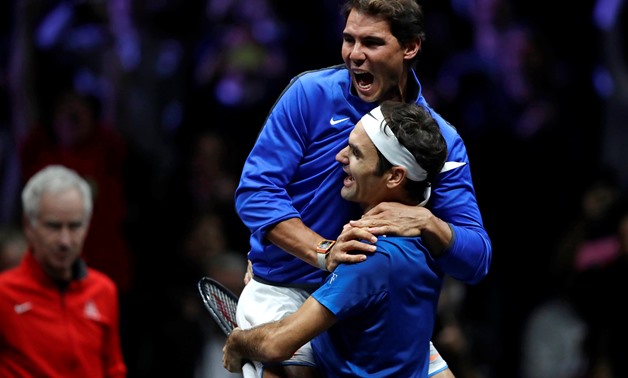 Rafael Nadal and Roger Federer celebrate after winning – Press image courtesy Reuters