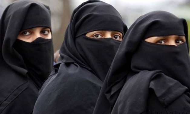 Women wearing full-face veils - Reuters