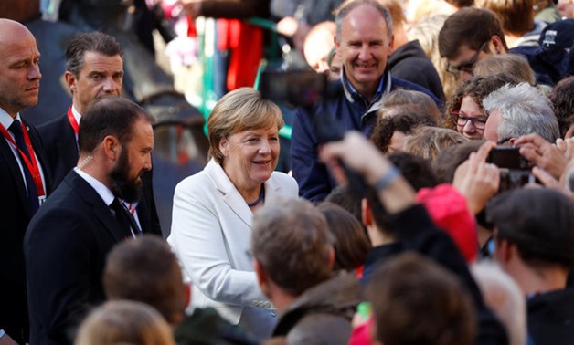German Chancellor Angela Merkel greets people during German Unification Day celebrations in Mainz, Germany, October 3, 2017. REUTERS