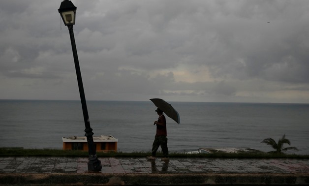 A man walks with an umbrella in the Hurricane Irma damaged Old San Juan in San Juan, Puerto Rico, October 9, 2017. REUTERS/Shannon Stapleton TPX IMAGES OF THE DAY

