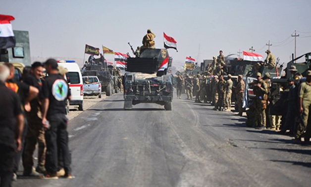 Members of Iraqi federal forces gather to continue to advance in military vehicles in Kirkuk. REUTERS