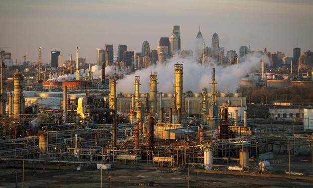 The Philadelphia Energy Solutions oil refinery owned by The Carlyle Group is seen at sunset in front of the Philadelphia skyline March 24, 2014. Picture taken March 24, 2014. REUTERS/David M. Parrott/File Photo
