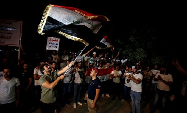 Iraqi people celebrate after Kirkuk was seized by Iraqi forces as they gather on the street of Baghdad -- REUTERS