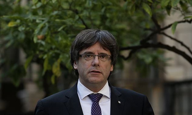 Catalan President Carles Puigdemont arrives for a meeting at the Palau Generalitat in Barcelona, Spain, Tuesday, Oct. 17, 2017. Spain's confrontation with its independence-seeking region of Catalonia intensified Monday when a judge ordered the leaders of 