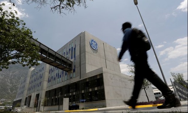 Man walks past the Global Operations Center of General Electric Co. in San Pedro Garza Garcia -- REUTERS