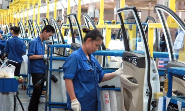 Employees work at a production line inside a factory of Saic GM Wuling, in Liuzhou, Guangxi Zhuang Autonomous Region, China, June 19, 2016. REUTERS/Norihiko Shirouzu - S1AETQJGBJAA