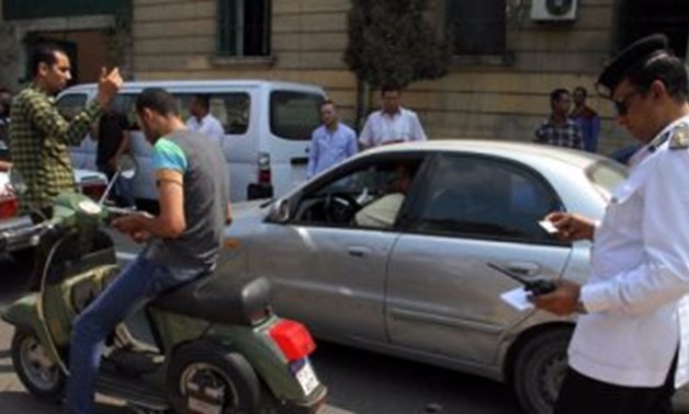 Photo of Egyptian traffic officer writes down an offence – File Photo