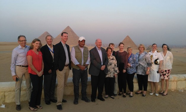 Peter Cosgrove together with work staff in front of the pyramids - File Photo 