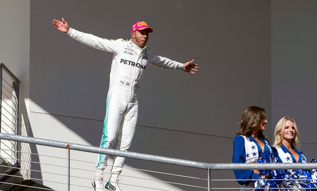 Mercedes driver Lewis Hamilton (44) of Great Britain celebrates winning the United States Grand Prix – Press image courtesy Reuters