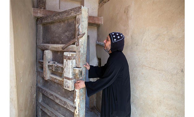 Father Cyrlis el-Parameosi at one of the doors of the Parameos Monastery, Wadi el-Natrun – Ahmed Hindy