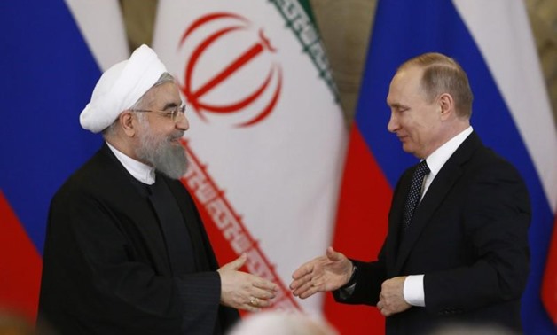 Russian President Vladimir Putin shakes hands with Iranian President Hassan Rouhani during a joint news conference following their meeting at the Kremlin in Moscow, Russia March 28, 2017. REUTERS/Sergei Karpukhin