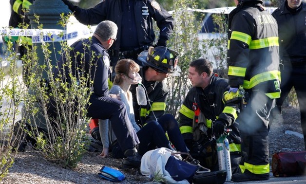 A woman is aided by first responders after sustaining injury on a bike path in lower Manhattan in New York - REUTERS
