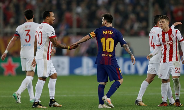 Barcelona’s Lionel Messi with Olympiacos' Filipe Pardo after the match REUTERS/Alkis Konstantinidis