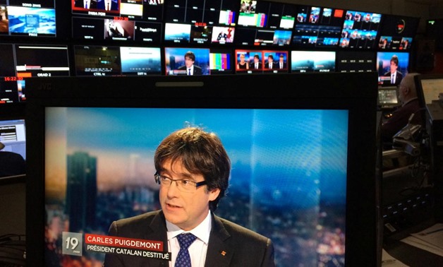 Ousted Catalan President Carles Puigdemont appears on a monitor during a live TV interview on a screen in a bar in Brussels, Belgium, November 3, 2017. REUTERS/Eric Vidal