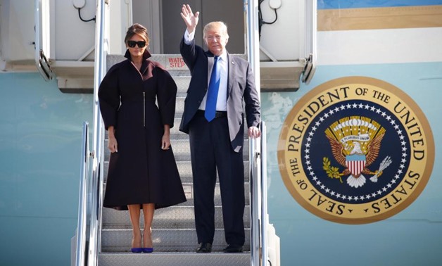 Donald Trump waved to the crowds when he arrived at Osan Air Base in South Korea with his wife Melania today - Ruetres