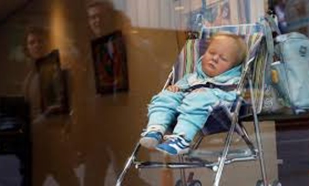 Artist Duane Hanson's sculpture titled "Baby in a Carriage, 1983," valued at about $80,000 to $120,000, is seen in the Park Avenue window of Heritage Auctions in New York City, New York, U.S., November 10, 2017. REUTERS/Shannon Stapleton